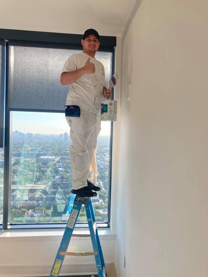 Gomez Painting About Technician on ladder installing or repairing window in high-rise building.