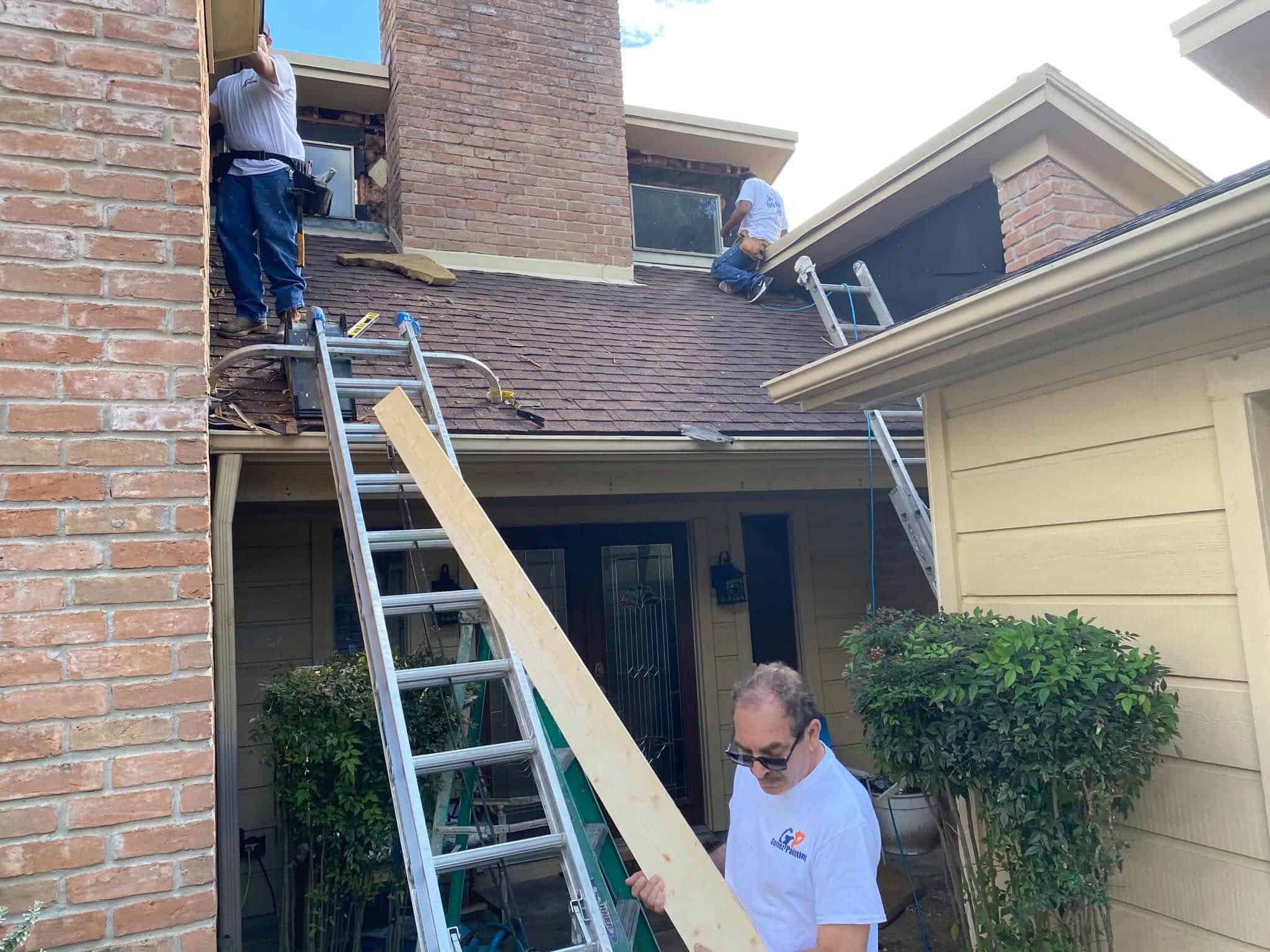 Gomez Painting Home renovation with workers applying gunite and shotcrete on the roof.