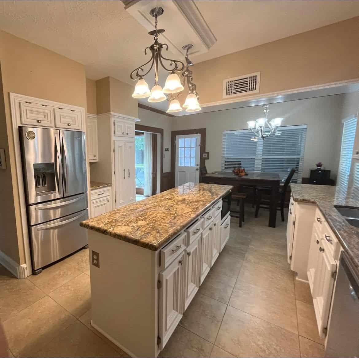Cabinets Modern kitchen with granite countertops and stainless steel appliances.