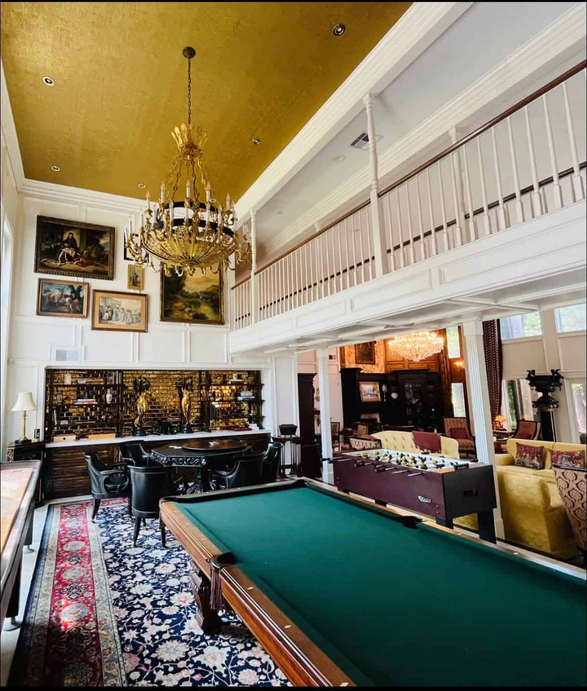Interior Painting Elegant living room with pool table, chandelier, and classic decor.