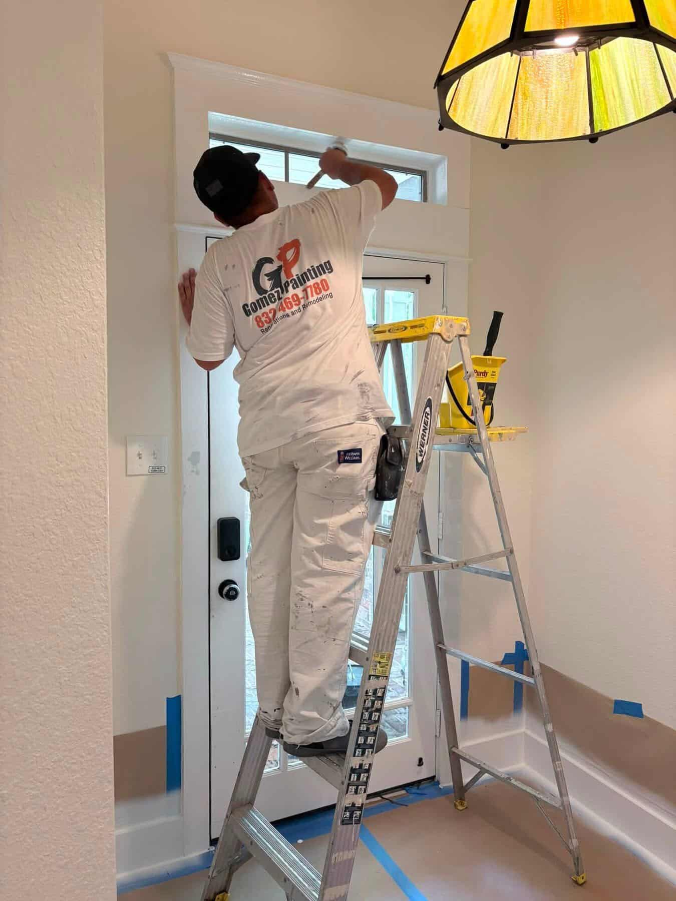 IMG_0229 Technician installing or repairing a door window with a ladder inside a home.